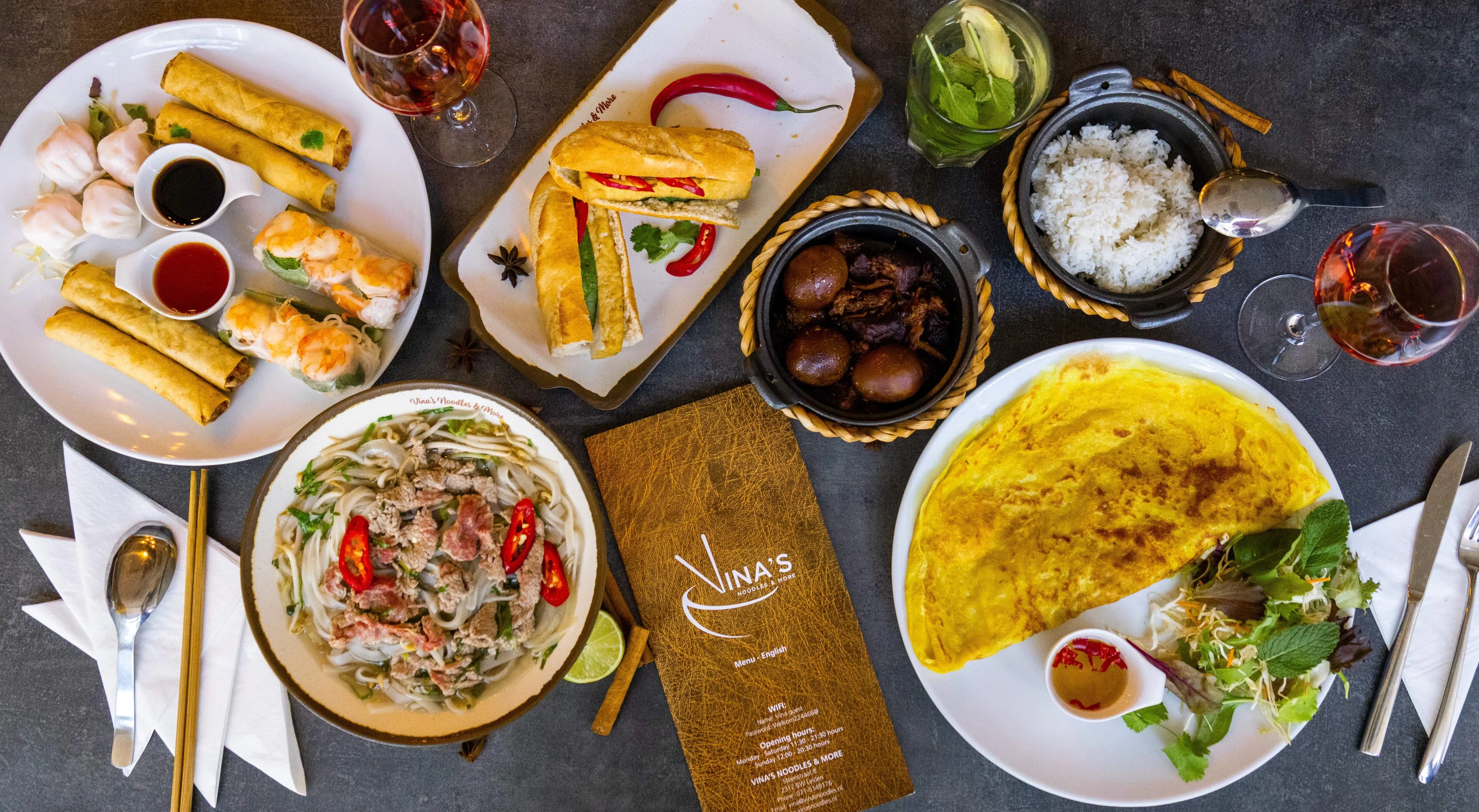 Fresh Vietnamese dishes and ingredients on a wooden table